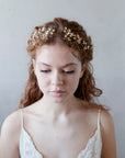 Accessorio per capelli da sposa con fiorellini dorati, ideale per un look romantico.