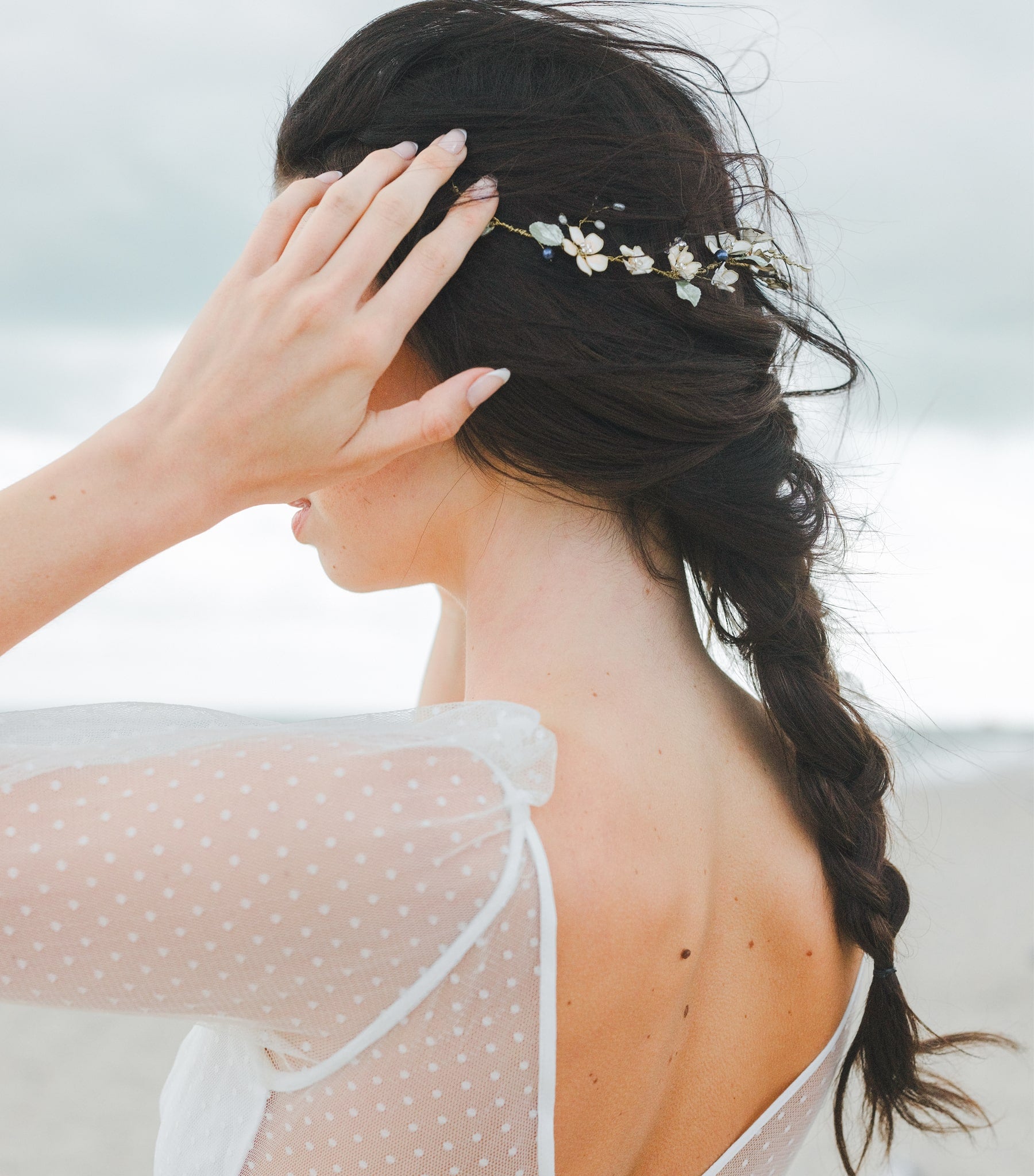 Coroncina floreale con perle blu e cristalli, ideale per un’acconciatura da sposa romantica.