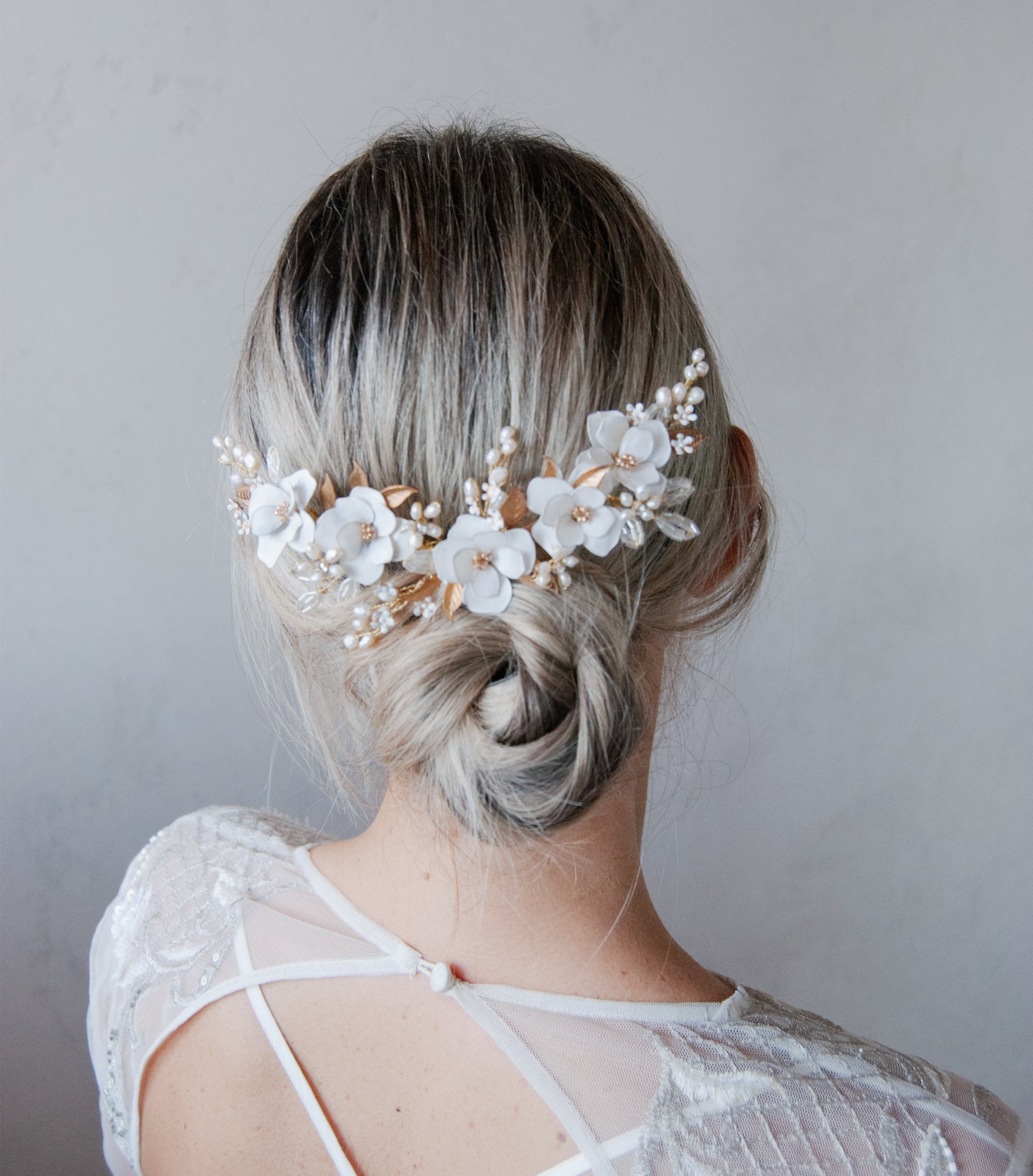 Accessorio per acconciature da sposa con peonie bianche e fiorellini decorativi.